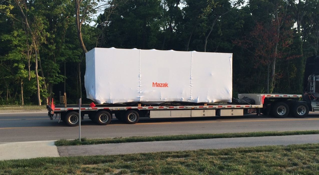 Equipment with a Transhield Custom Cover on the back of a Semi for Transportation