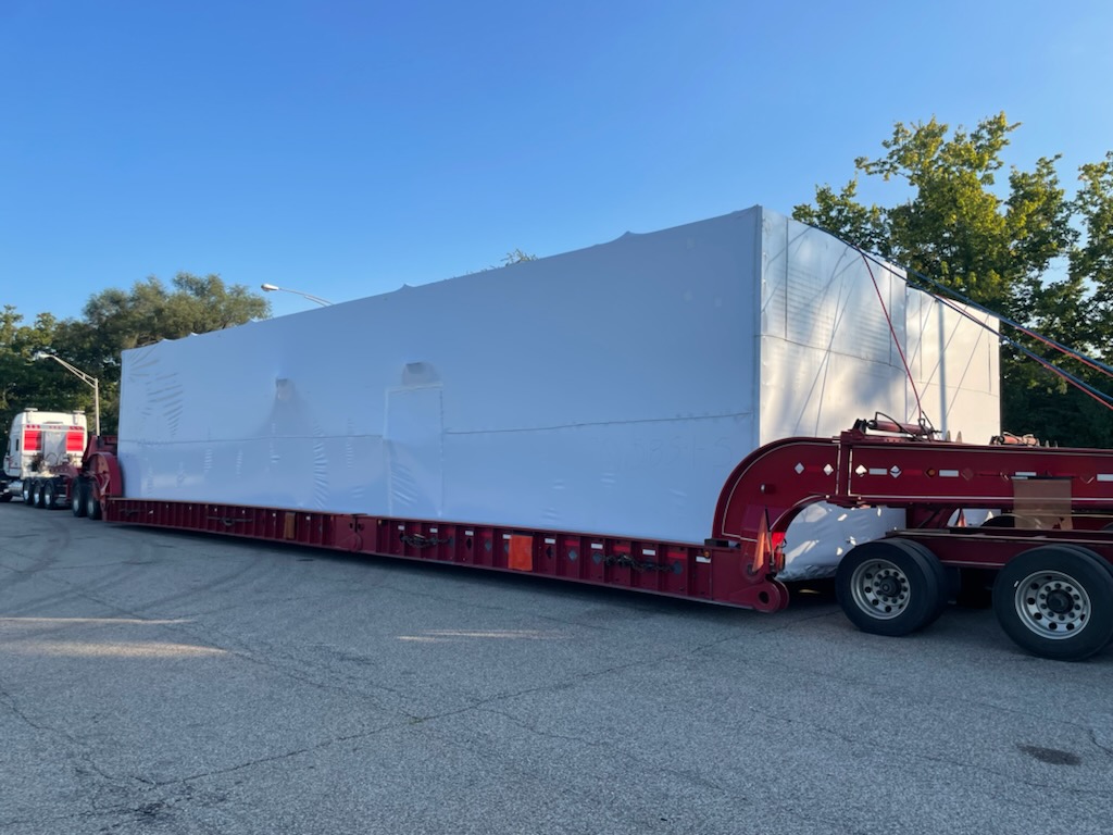 Modular Enclosure On a Semi Truck with a Protective Cover, Ready for Transport