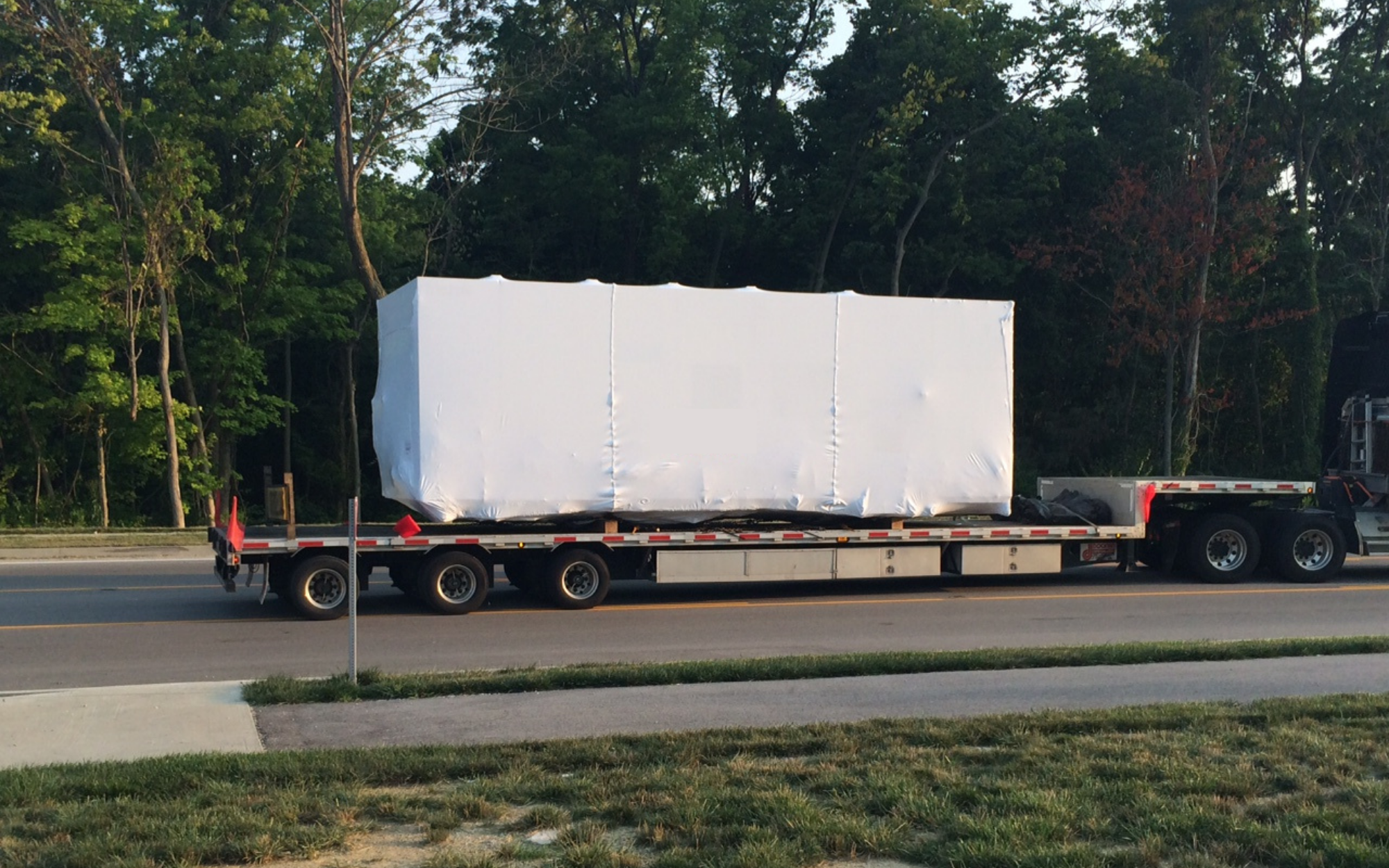 Equipment with a Transhield Custom Cover on the back of a Semi for Transportation