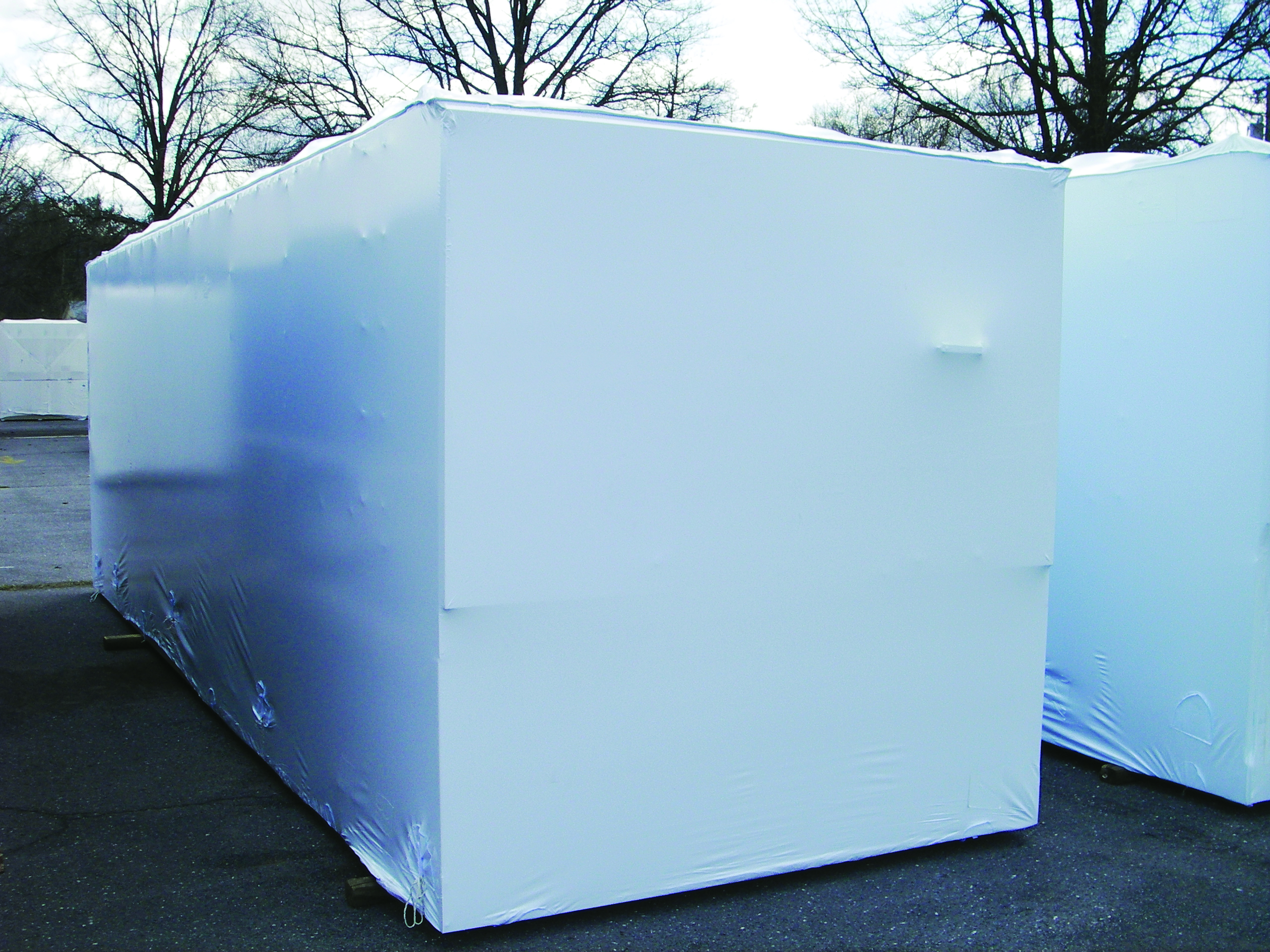 longer rectangular machinery with cover stored outside