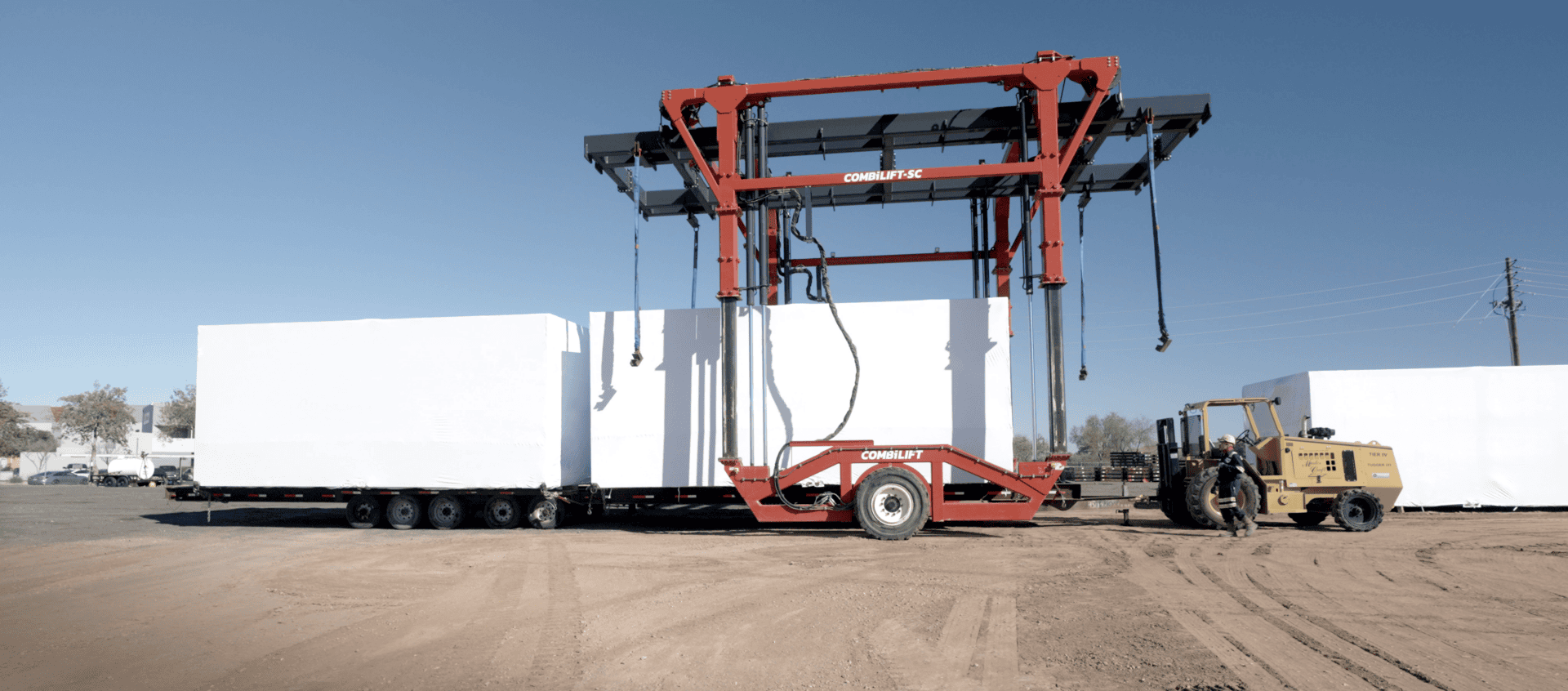 Large Covered Equipment Getting Loaded onto a Semi Flat Bed
