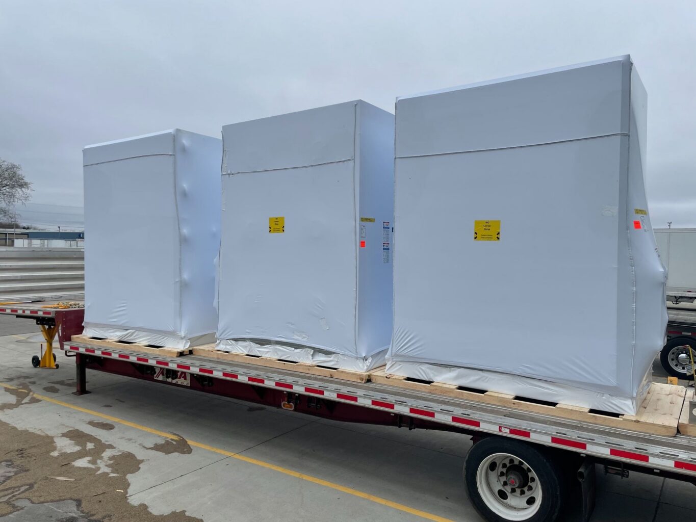 three boxes covered in a Transhield cover on a truck