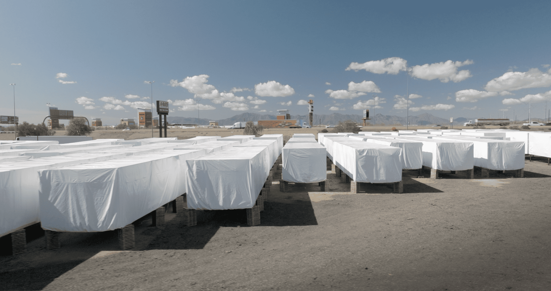 large equipment being stored outdoors under transhield covers