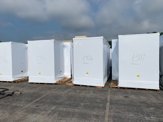 electrical skids covered with a transhield covers sitting on a lot