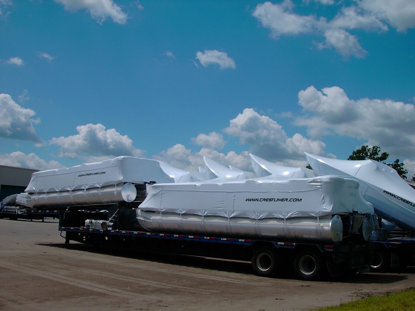 multiple boats wrapped and ready for transport