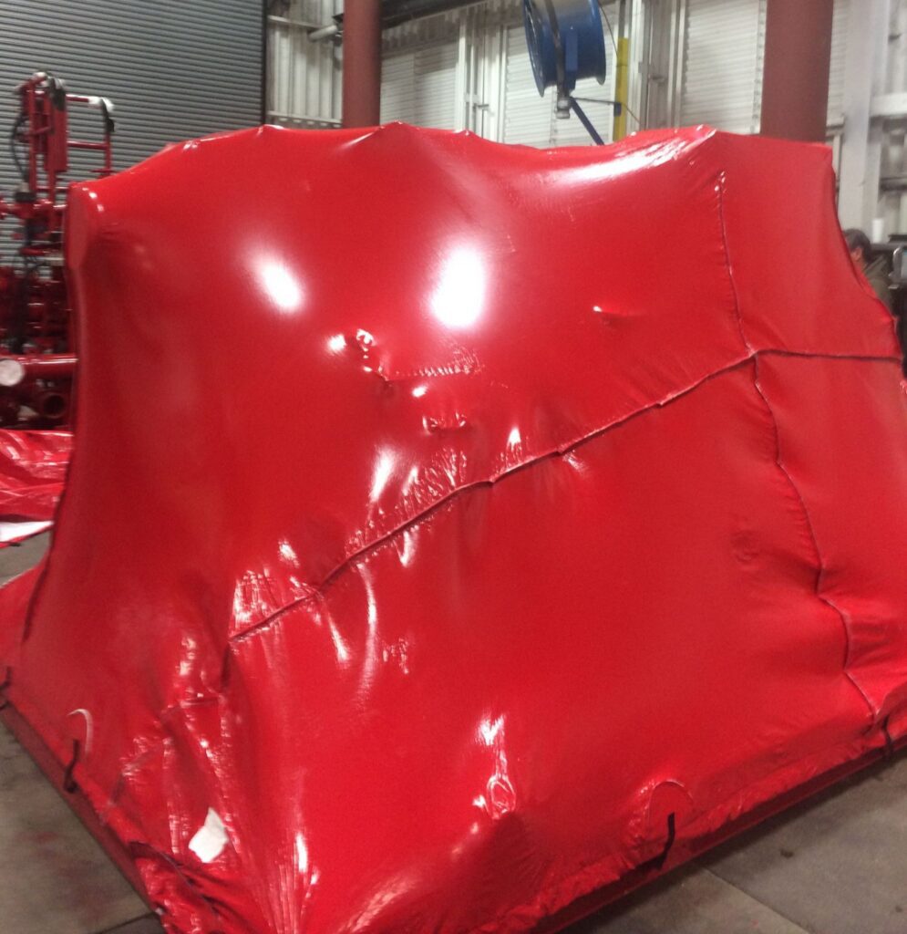 machinery covered with a bright red transhield cover